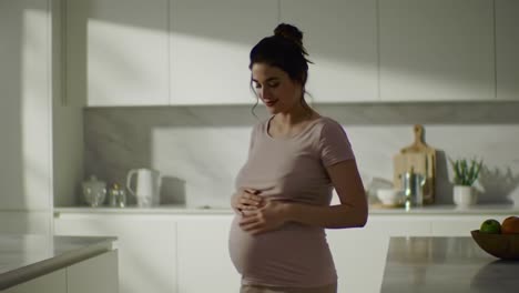 a joyful expecting mother embracing her pregnancy in a bright modern kitchen, capturing moments of anticipation and love during this special time