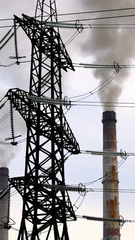 ecological problems. transmission lines near the industry. thick smoke from pipes filling the air. chemical fumes pollute the atmosphere. vertical video