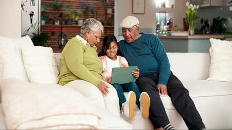 Grandparents and Grandchild using a Tablet