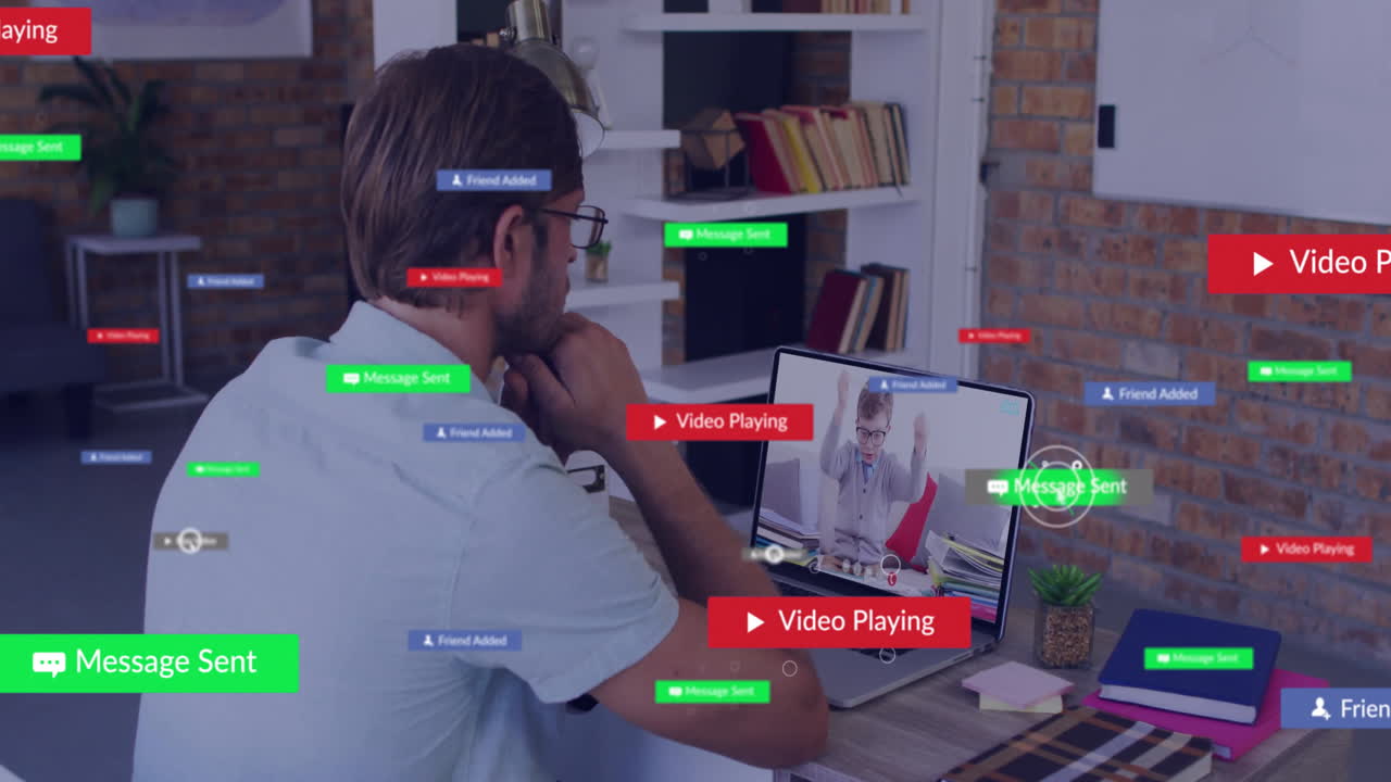 Working at desk, man using computer with animation of social media notifications