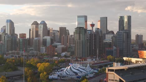 the downtown core of calgary alberta is seen from a aerial drone point of view with the stampede grounds in the foreground