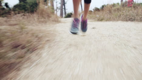 woman running trail close up shoes steadicam shot