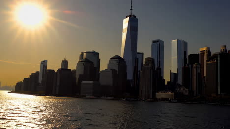 new york city skyline with one world trade center at sunset