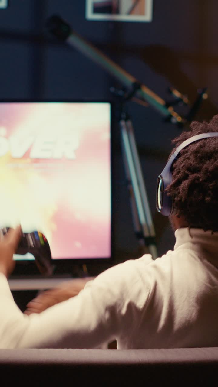 Vertical video Gamer receiving game over screen on television set, getting his spaceship destroyed