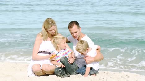 happy family sitting on the beach