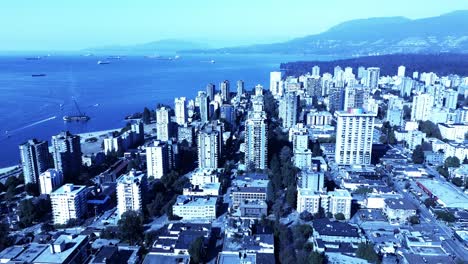 davie street gay pride village community summer flyover west end of downtown area of celebration while beached barge dismantle island sits at foot of false creek