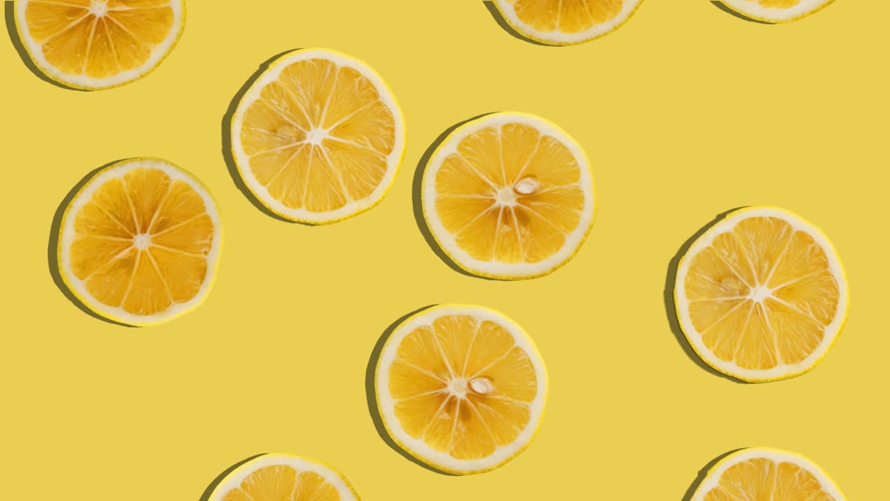 Background of lemon slices falling. Fresh fruit. Loop. 4K.