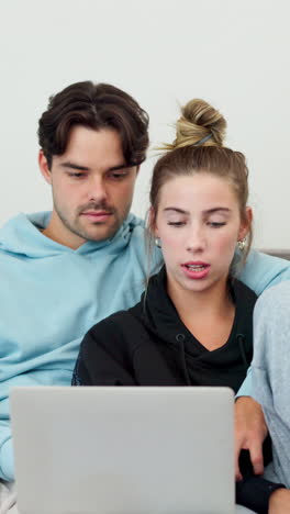 couple using laptop together at home