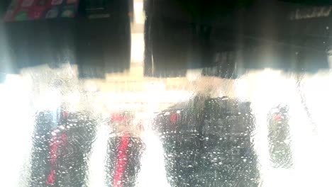 auto fährt durch eine werkstatt für automatische autowaschmaschinen, blick aus dem innenraum des autos