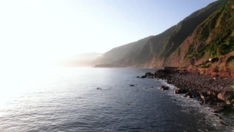 Aerial-view-flyover-ocean-with-volcanic-green-rocky-coast,-Madeira,-Low-angle