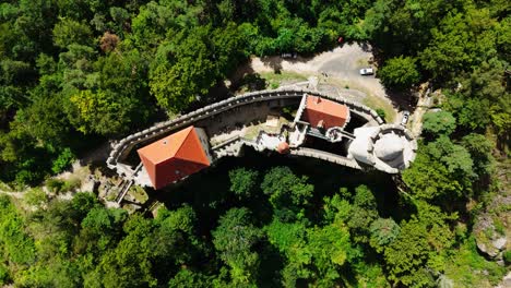aerial top down descend over historic kokorin castle near green forest, czechia