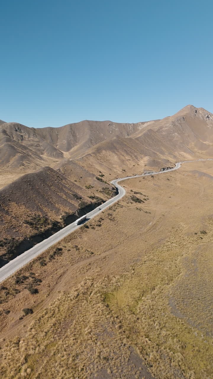 Aerial View of Winding Road Through Mountainous Terrain