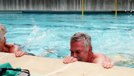 Seniors-swimming-in-the-pool-with-inflatable-tubes