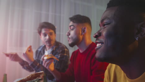 friends enjoying pizza and watching tv