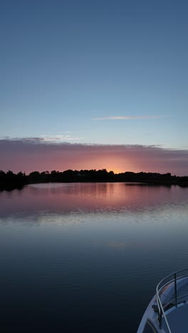serene river sunset with colorful sky and water reflection
