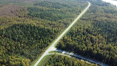 aerial drone shot over road near river in iceland