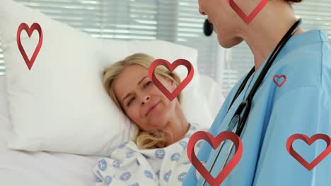 Animation-of-falling-heart-icons-over-caucasian-male-doctor-with-caucasian-female-patient