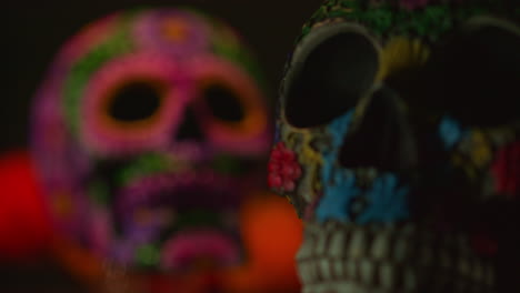 close up on still life of decorated skulls celebrating mexican holiday of dia de muertos or day of the dead 1