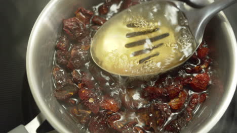 boiling sundried tomatoes in a pot full of hot water