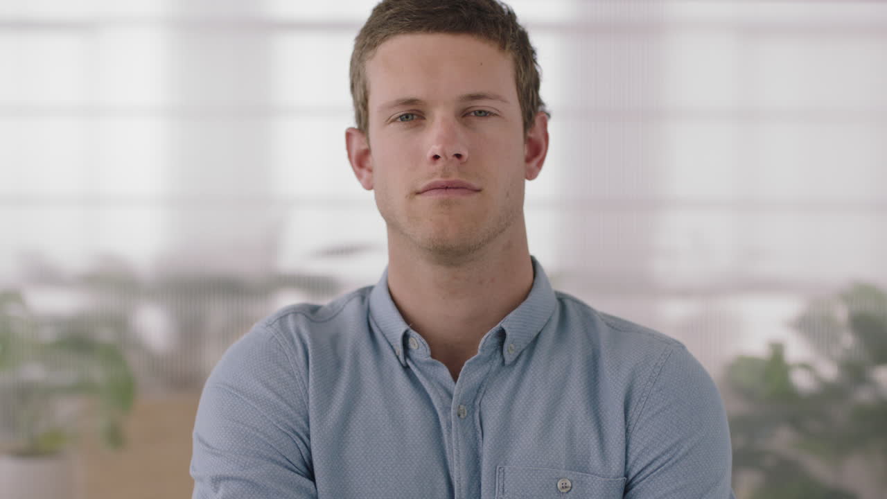 portrait of attractive young businessman entrepreneur looking serious confident at camera arms crossed caucasian male leadership responsibility