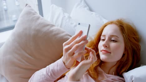 woman using mobile phone in bedroom 4k