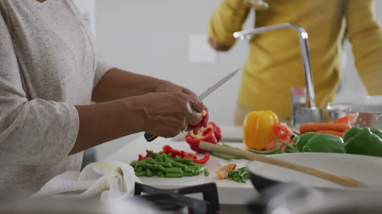 A senior African american couple cooking at home. Social distancing in quarantine
