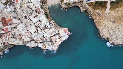 top drone shot of a gulf, with a small rocky beach