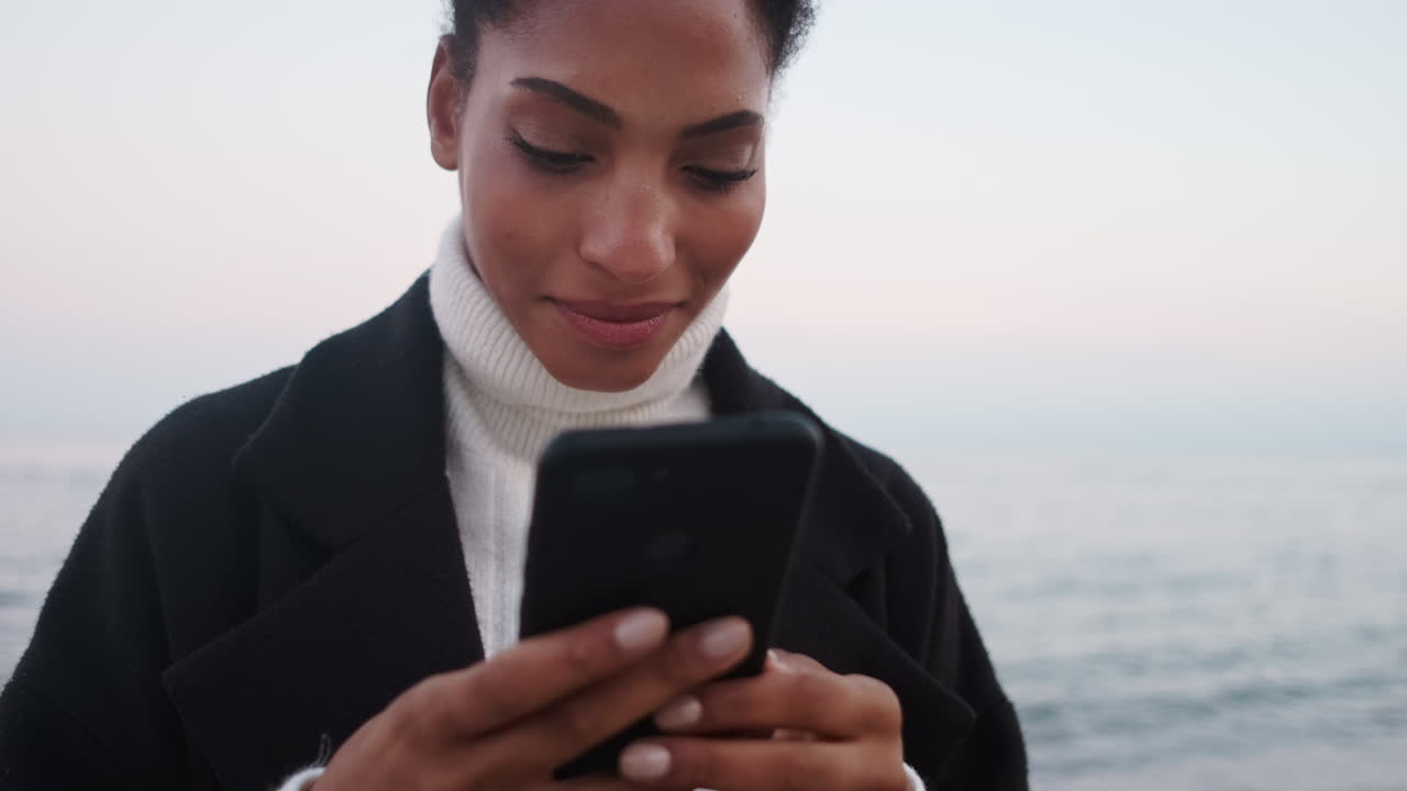 African American girl using mobile phone.
