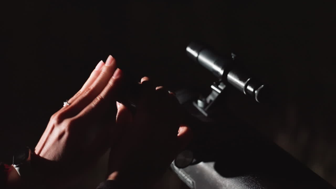 closeup hands attaching eyepiece under sky. amateur astronomer fits circular filter and rotates focusing ring, quick movements signal anticipation, studiodark background with dramatic shadow, brief
