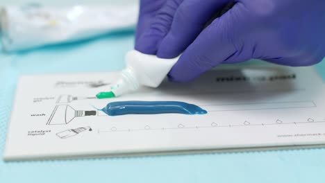 stomatolog squeezing silicone material for dental imprint. dental technician