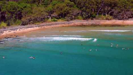 scenic view of tourist surfing at noosa national park near noosa heads in queensland, australia