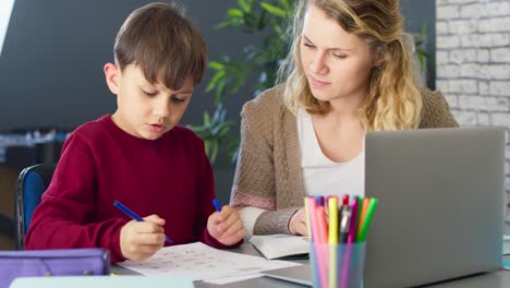 Handheld-video-of-mother-helping-her-son-with-schoolwork