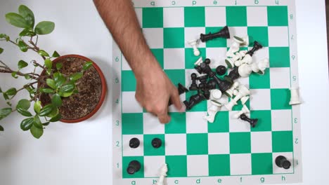 male hand placing chess pieces on the board