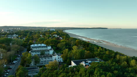 aerial view of a coastal resort town with beach and forest