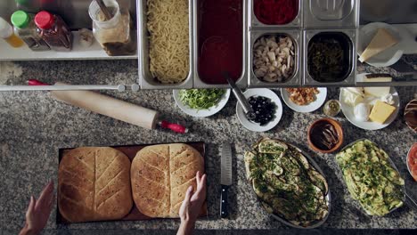 baker putting tray with hot focaccia on table