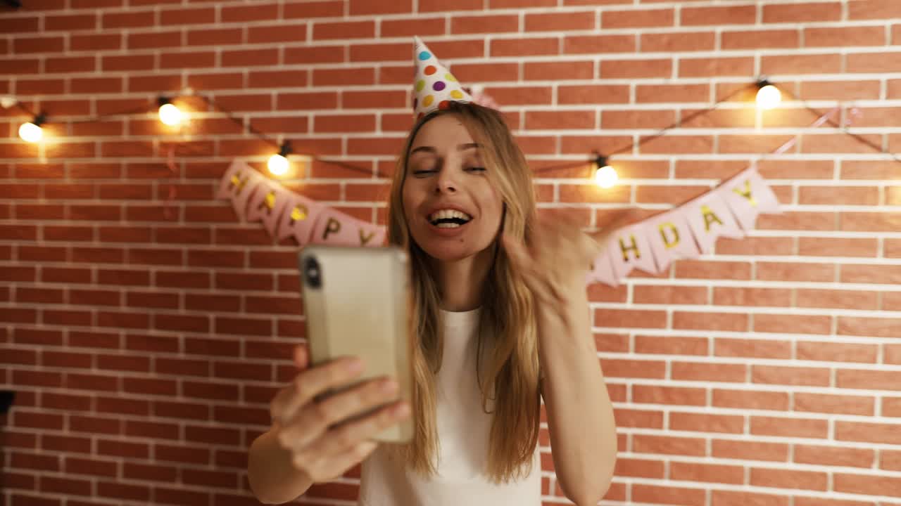 Excited girl shout Happy Birthday on smartphone's camera