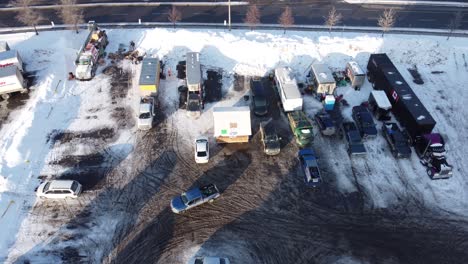 aerial: frozen parking lot acting as freedom convoy base camp beside highway at morning in ottawa, ontario, canada