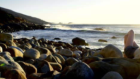 woman relaxing on the beach at dusk 4k