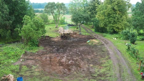 aerial view of cleaned countryside yard, fresh dirt ground after removing trash