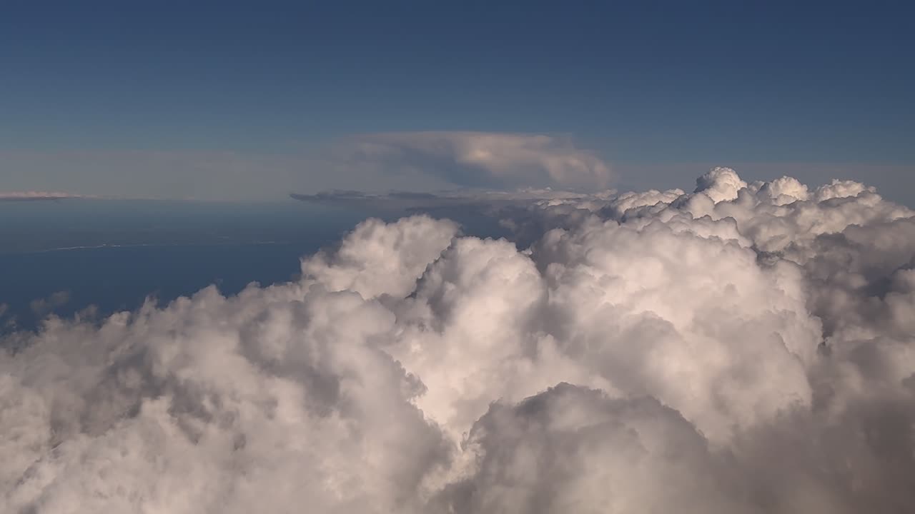 Immersive pilot’s eye perspective while flying over storm clouds over the Mediterranean Sea at the blue hour