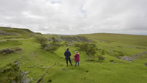 mother and daughter on a scenic hike in a welsh quarry landscape