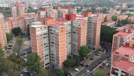 drone's aerial perspective of red apartment buildings in mexico city