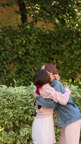 two friends hugging outdoors