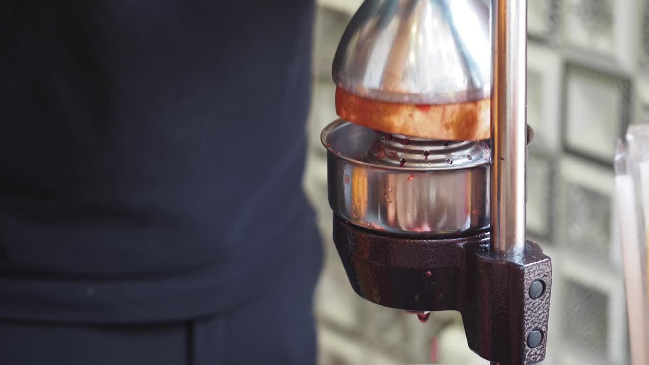 Making Fresh Fruit Juice with a Manual Juicer