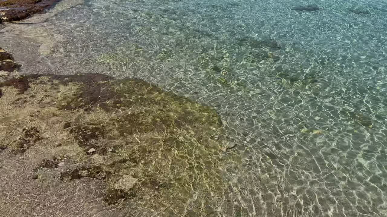 Stunning beach scene in Halkidiki, Greece, with elegant sunbeds facing the crystal-clear turquoise sea. A perfect summer escape in the heart of the Aegean.