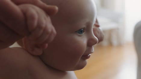 happy baby learning to walk toddler taking first steps with mother helping infant teaching child at home