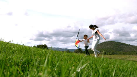 Mother-and-daughter-running-with-kite