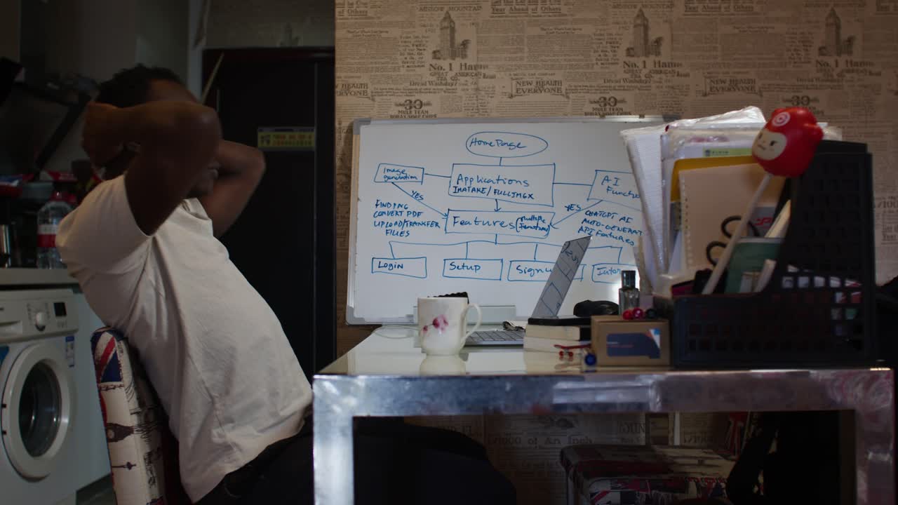 Focused man works intensely on laptop at home office, determination visible