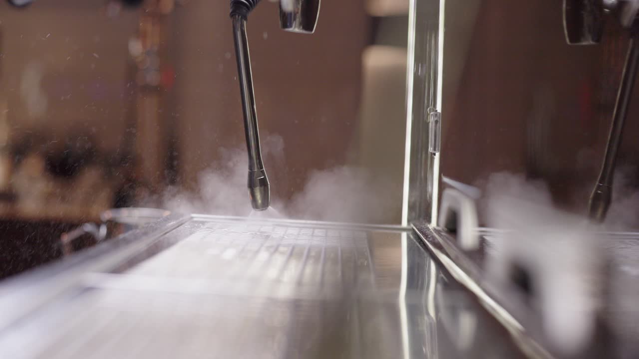 Cleaning milk steamer, coffee steamer steaming up lense, coffee machine