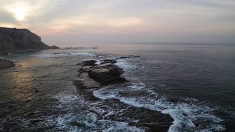 waves crashing off the coast of california
